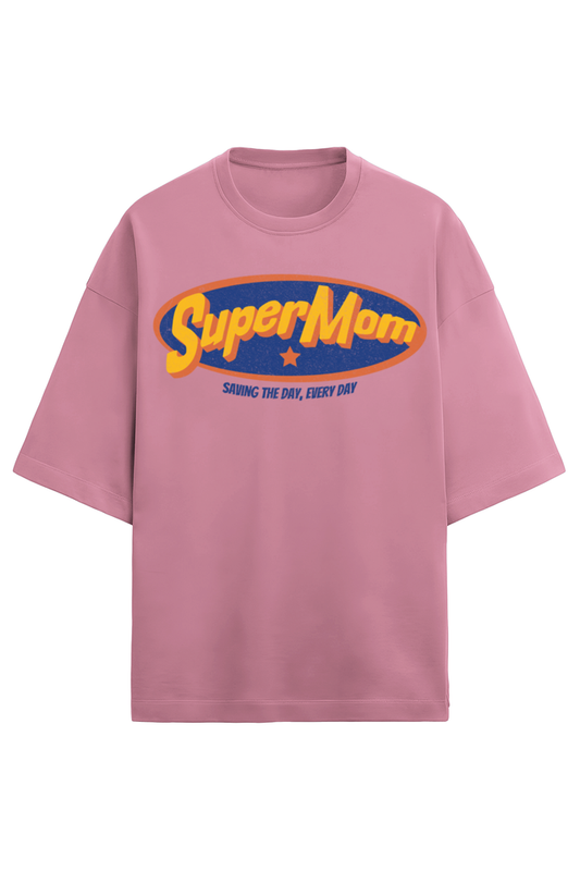 baby pink oversized women’s T-shirt in 280 GSM French Terry cotton with a retro comic-style “SuperMom” print and the phrase “Saving the Day, Every Day”