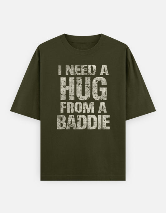Green t-shirt with text 'I Need a Hug from a Baddie' on a white background
