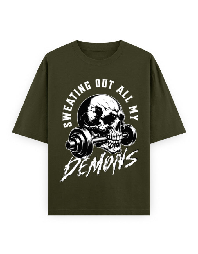 Green t-shirt with skull and barbell graphic and text 'Sweating Out All My Demons' on a white background