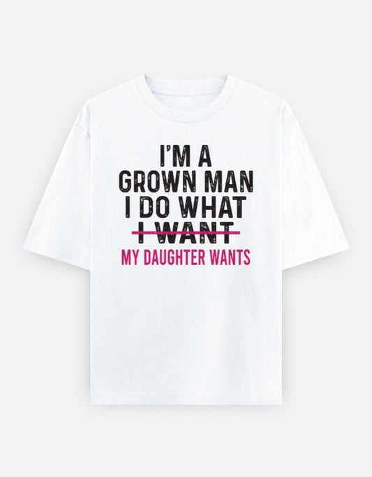 Frolic Saga white 100% cotton oversized tee with black and pink text graphic reading "I'm A Grown Man I Do What I Want My Daughter Wants"