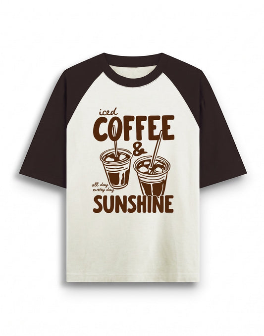 Cream and brown oversized raglan t-shirt featuring a dark brown graphic of two iced coffee cups and text that reads iced COFFEE & all day every day SUNSHINE.