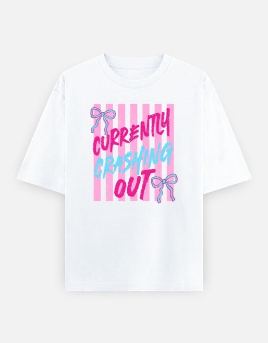 Frolic Saga white 100% cotton oversized t-shirt with pink and blue 'Currently Crashing Out' graphic and pink stripes.