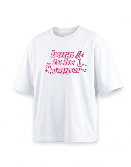 Frolic Saga white 100% cotton oversized t-shirt with pink "born to be a yapper" graphic and microphone design.