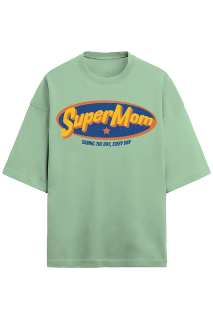 jade green oversized women’s T-shirt in 280 GSM French Terry cotton with a retro comic-style “SuperMom” print and the phrase “Saving the Day, Every Day”