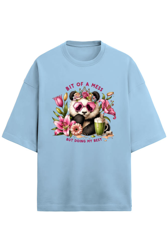 An oversized white French Terry tee in 280 GSM with a colorful print of a panda wearing pink sunglasses and a floral crown, surrounded by flowers and a smoothie. The text reads "BIT OF A MESS BUT DOING MY BEST."