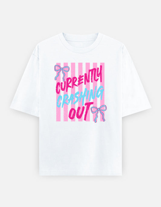 White t-shirt with pink and blue text and graphics on a white background. Currently Crashing Out Oversized T-Shirt - Coquette Graphic Tee