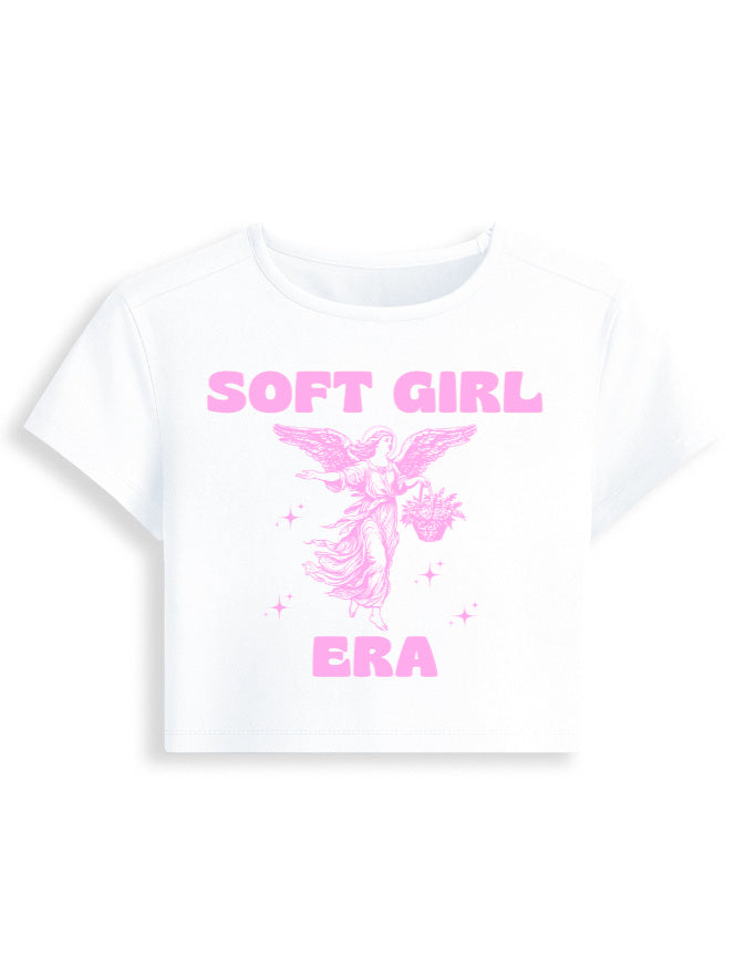 White t-shirt with pink 'SOFT GIRL ERA' text and graphic on a white background