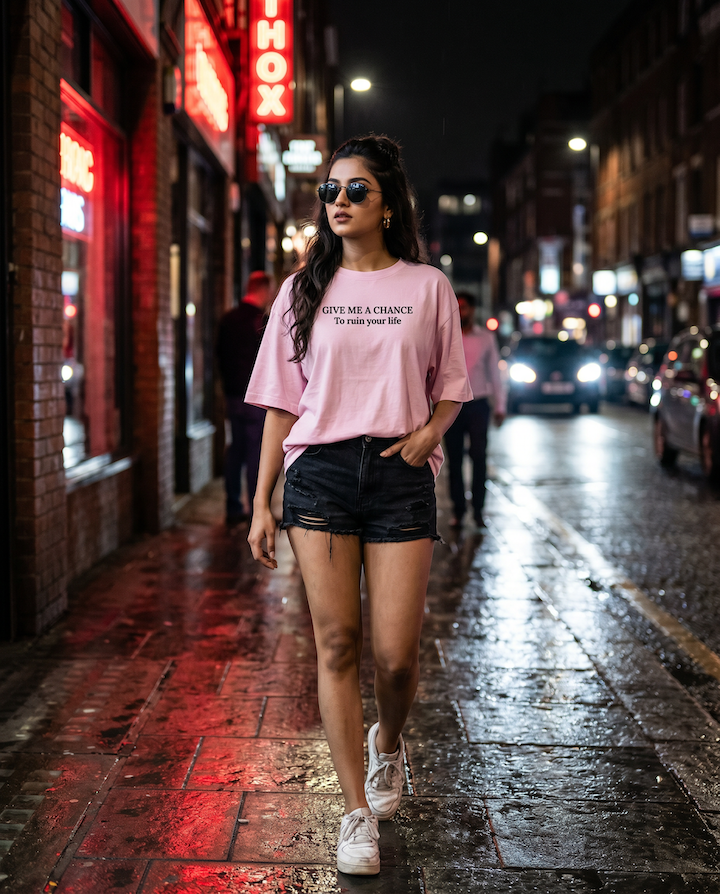 Woman walking on a city street at night with neon signs and wet pavement.