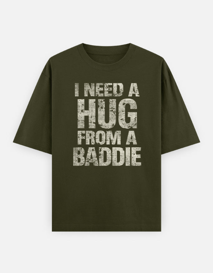 Green t-shirt with text 'I Need a Hug from a Baddie' on a white background
