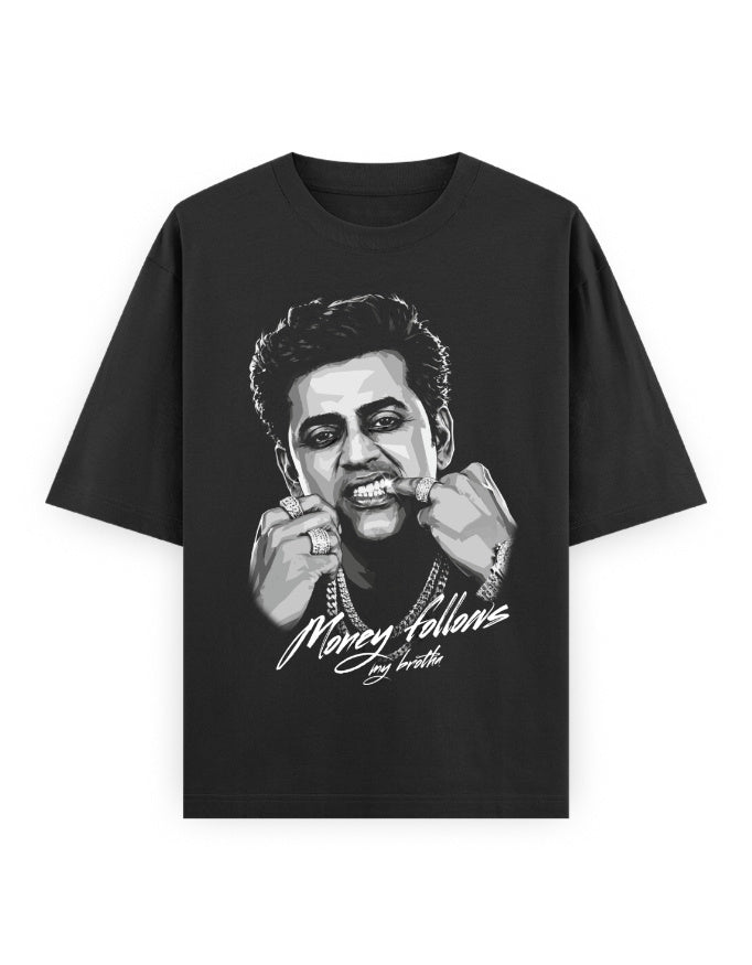 Black oversized t-shirt featuring a greyscale illustrated portrait of Ravi Kishan showing off his rings, with white script text below reading Money follows my brotha.