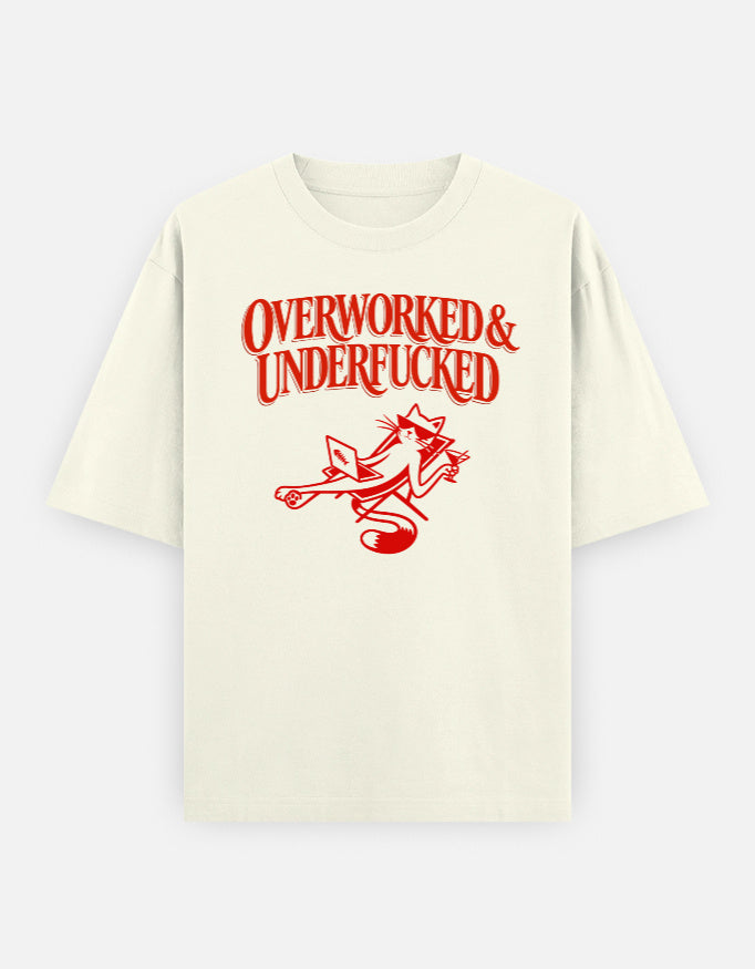 Beige t-shirt with red text 'OVERWORKED & UNDERFUCKED' and a graphic on a white background