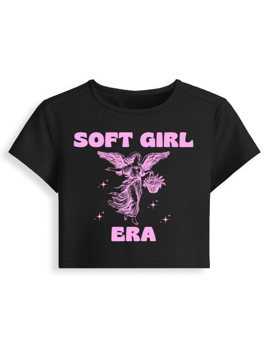 Black t-shirt with pink 'SOFT GIRL ERA' text and angel graphic on a white background