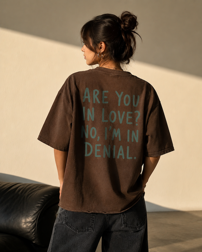 Brown oversized boxy fit French Terry cotton t-shirt featuring "Are You in Love? No, I'm in Denial." back print with raw hem detail.