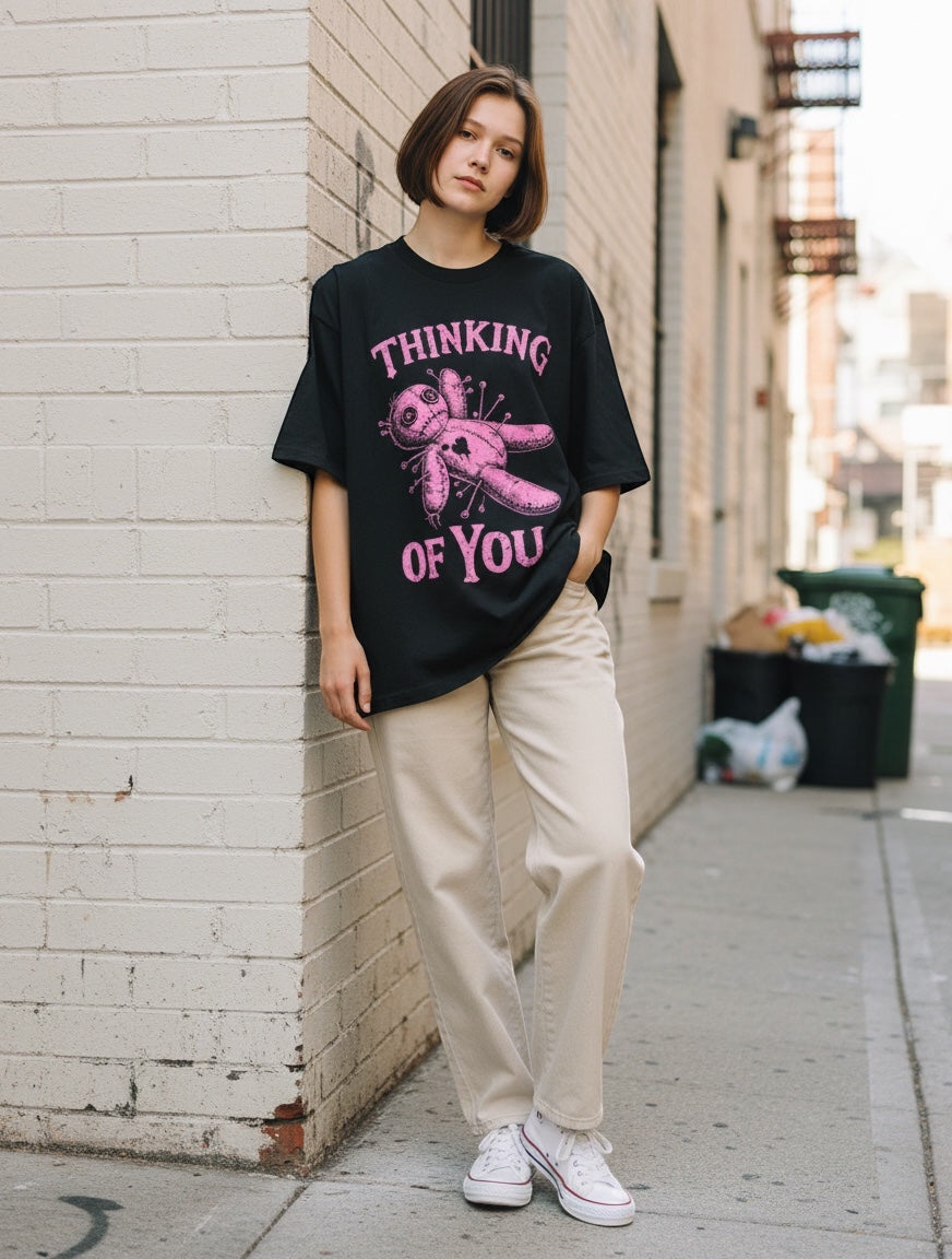 Frolic Saga black oversized t-shirt with pink distressed voodoo doll graphic and