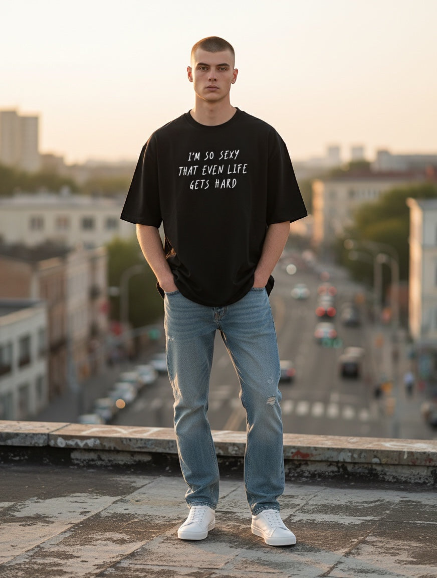 Frolic Saga unisex oversized black 100% cotton t-shirt with white text graphic and relaxed fit.