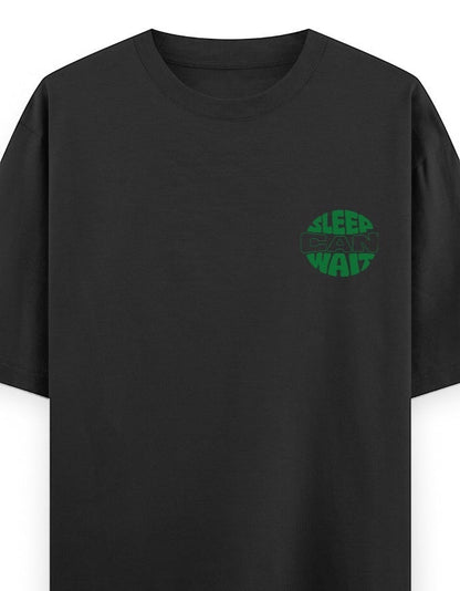 Frolic Saga black 100% cotton oversized t-shirt with green circular 'Sleep Can Wait' graphic on chest.