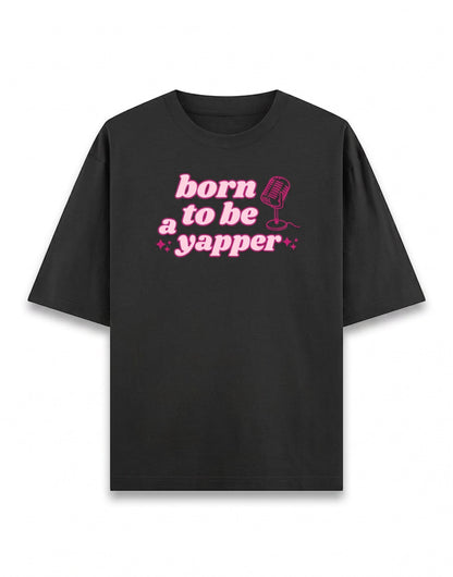 Frolic Saga Unisex oversized classic black 100% cotton t-shirt with pink "born to be a yapper" graphic and microphone.