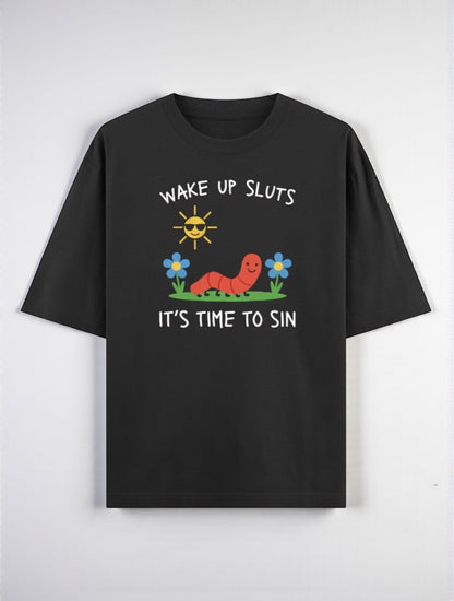 Frolic Saga black 100% cotton oversized t-shirt with a graphic print of a smiling worm, sun, and flowers. Text reads "WAKE UP SLUTS IT'S TIME TO SIN."