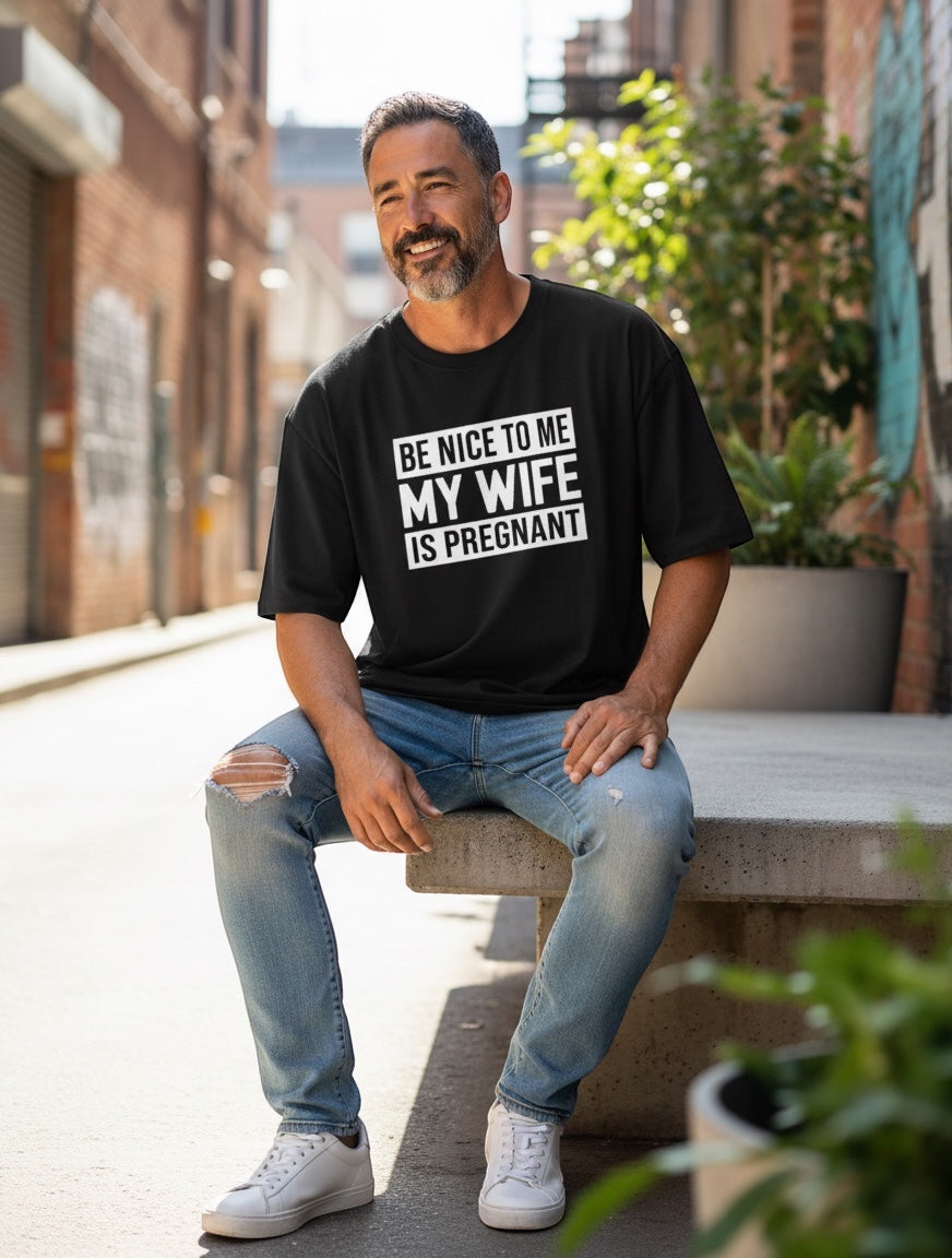 Frolic Saga black 100% cotton oversized t-shirt with "BE NICE TO ME MY WIFE IS PREGNANT" graphic print.