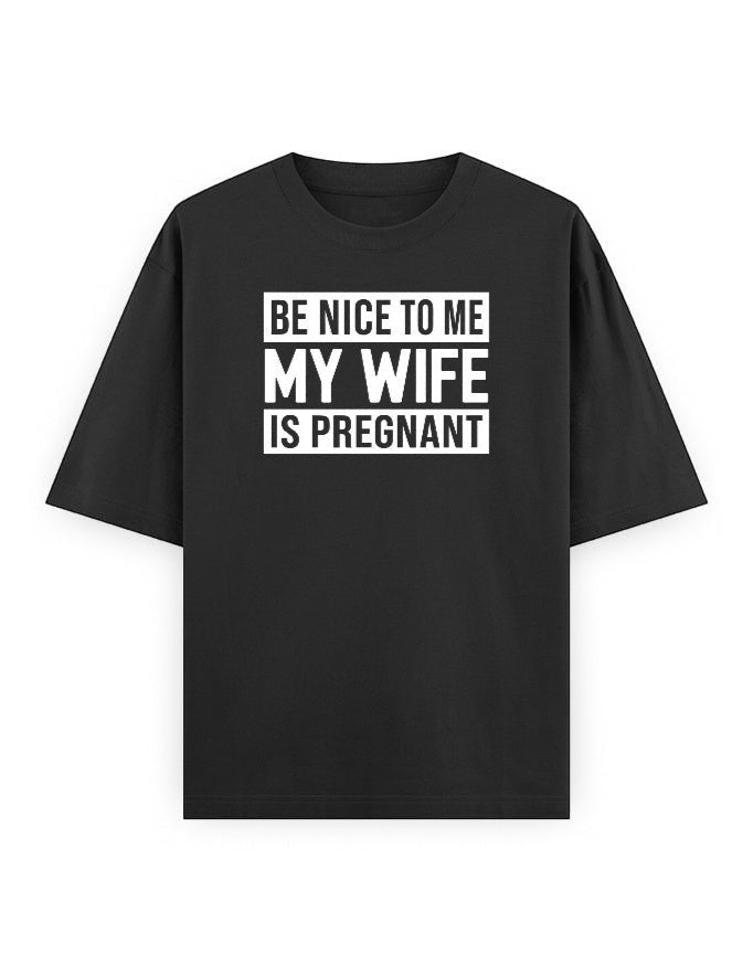 Frolic Saga black 100% cotton oversized t-shirt with white text graphic: "BE NICE TO ME MY WIFE IS PREGNANT"