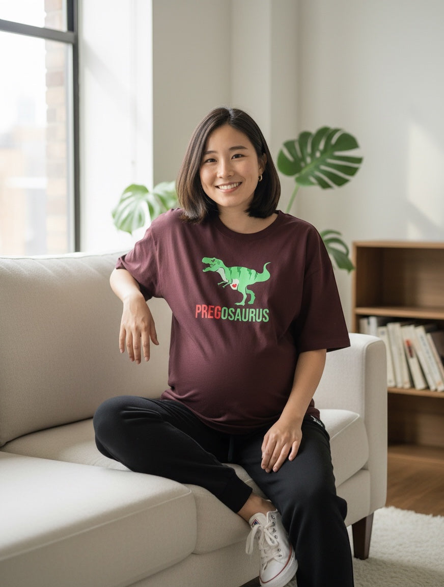 Frolic Saga burgundy 100% cotton oversized t-shirt with "PREGOSAURUS" dinosaur graphic for maternity wear.