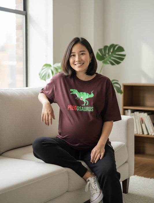 Frolic Saga burgundy 100% cotton oversized t-shirt with "PREGOSAURUS" dinosaur graphic for maternity wear.