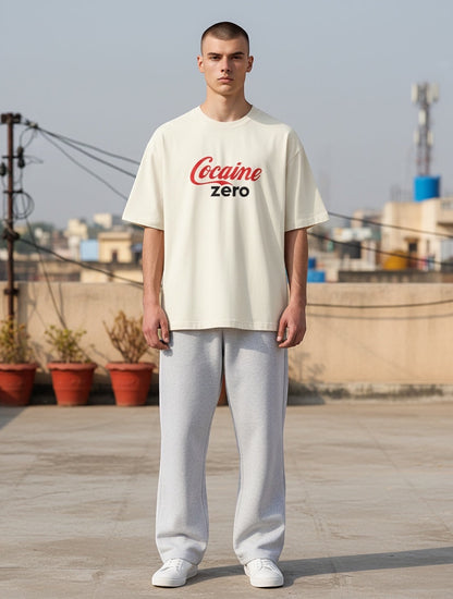 Frolic Saga oversized cream t-shirt with red and black 'Cocaine Zero' graphic print, 100% cotton.