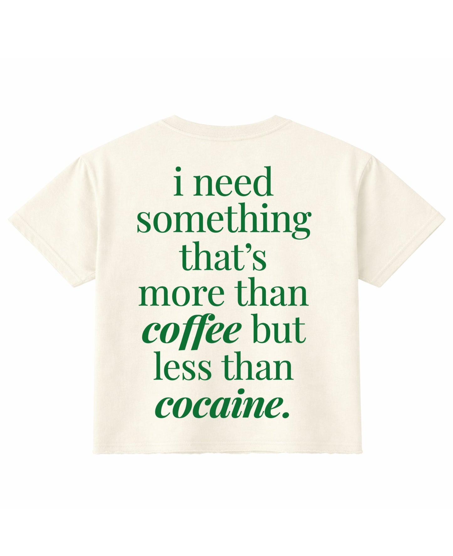 Frolic Saga cream cropped t-shirt with green text on the back reading I need something that is more than coffee