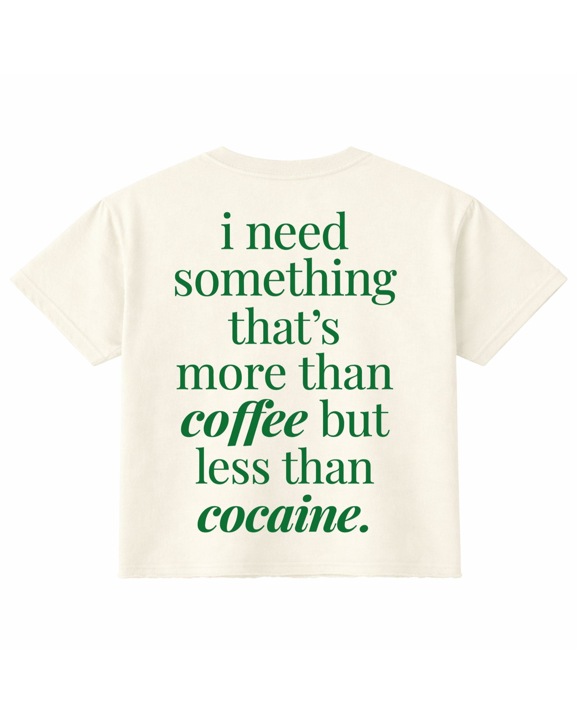 Frolic Saga cream cropped t-shirt with green text on the back reading I need something that is more than coffee