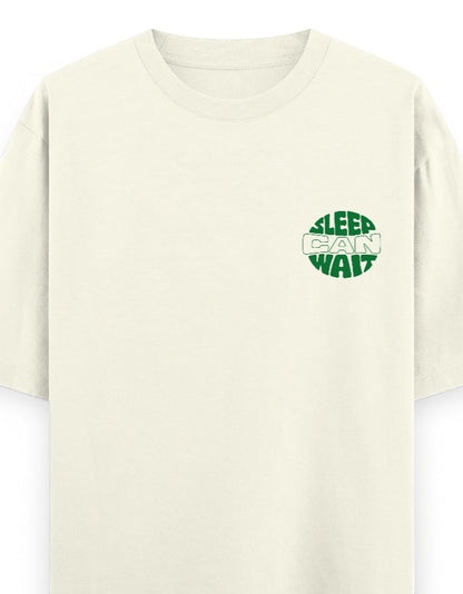 Frolic Saga cream 100% cotton oversized t-shirt with green 'Sleep Can Wait' graphic on left chest.