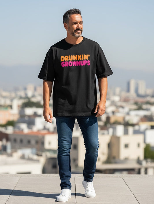 Frolic Saga black oversized t-shirt with "Drunkin' Grownups" graphic in orange and pink typography. 100% cotton.