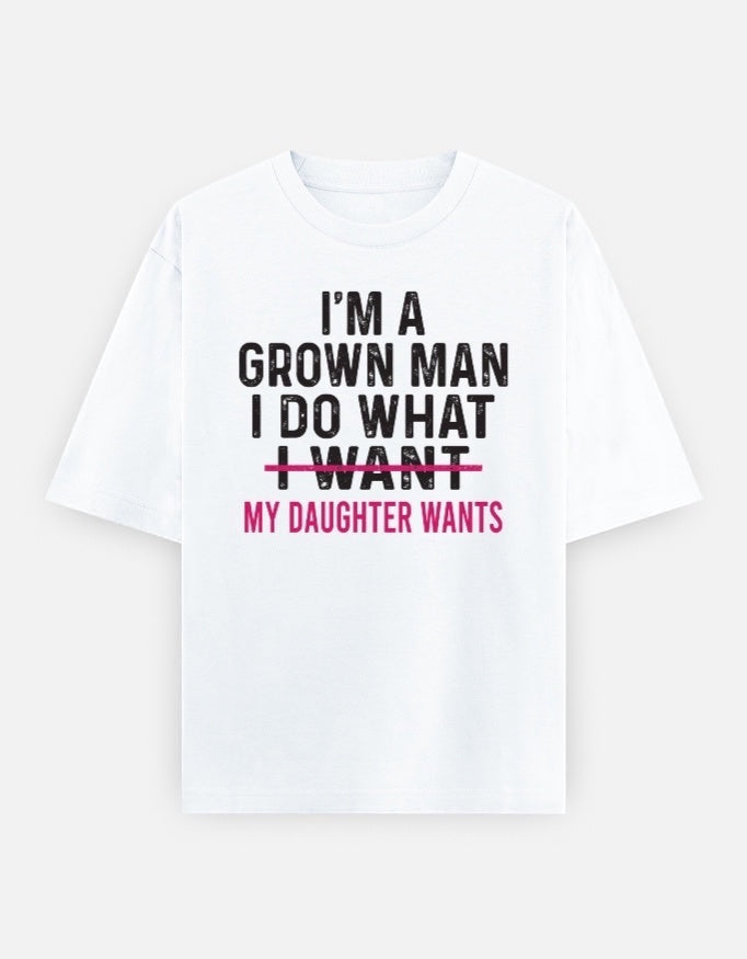 Frolic Saga white 100% cotton oversized tee with black and pink text graphic reading "I'm A Grown Man I Do What I Want My Daughter Wants"