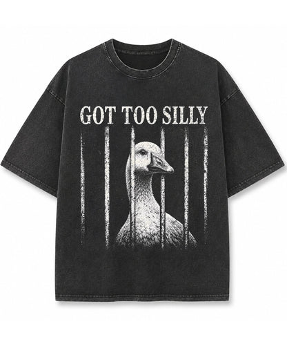 Vintage fade black oversized t-shirt featuring a distressed white graphic of a goose looking through jail bars, positioned under text that reads Got Too Silly.