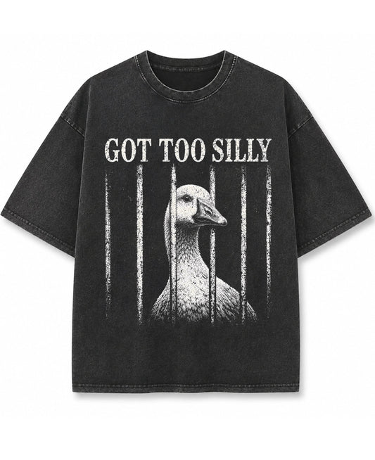 Vintage fade black oversized t-shirt featuring a distressed white graphic of a goose looking through jail bars, positioned under text that reads Got Too Silly.