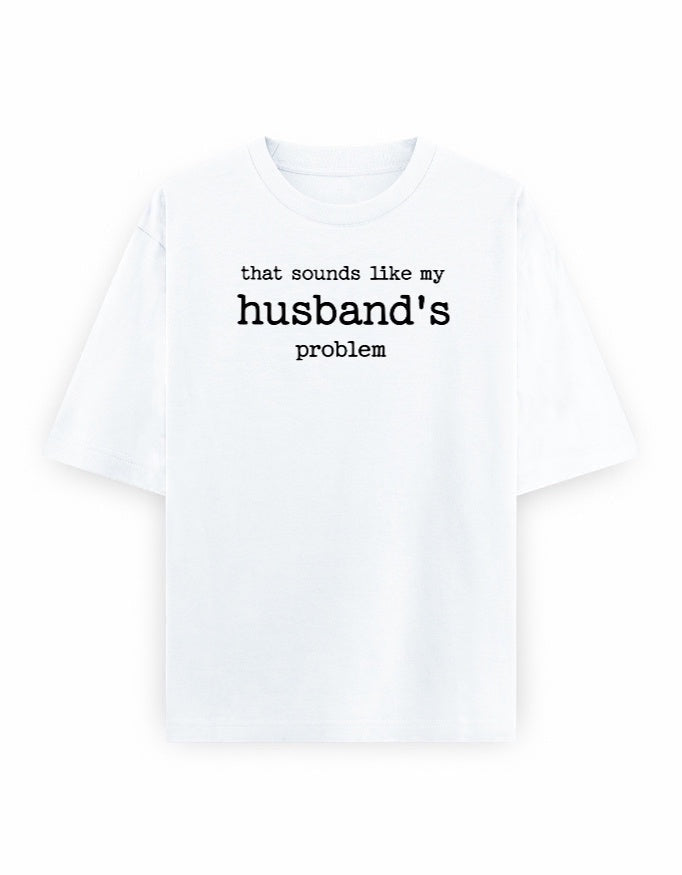 Frolic Saga white 100% cotton oversized t-shirt with black text graphic that says "that sounds like my husband's problem."