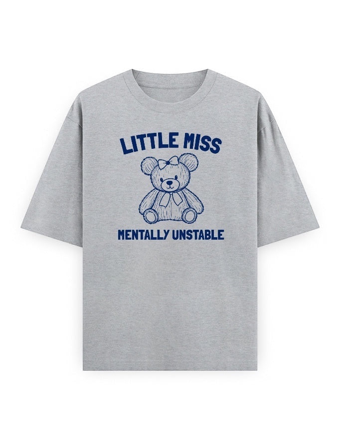 Frolic Saga grey oversized cotton t-shirt with a navy blue graphic of a teddy bear and text "Little Miss Mentally Unstable".
