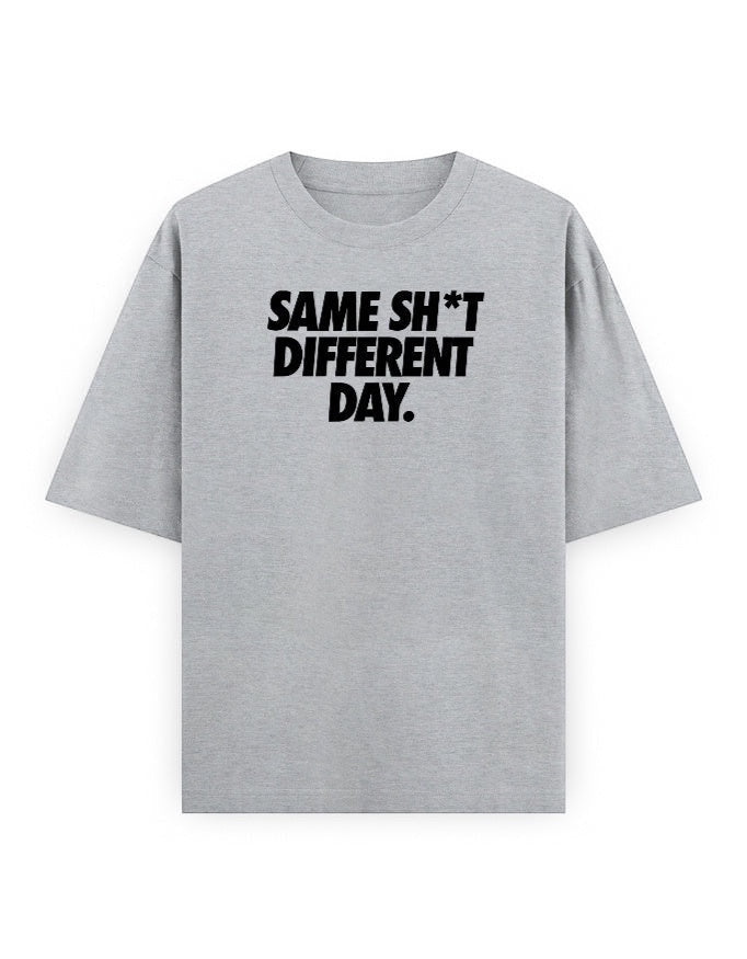 Frolic Saga grey 100% cotton oversized t-shirt with black text graphic 'SAME SH*T DIFFERENT DAY.'