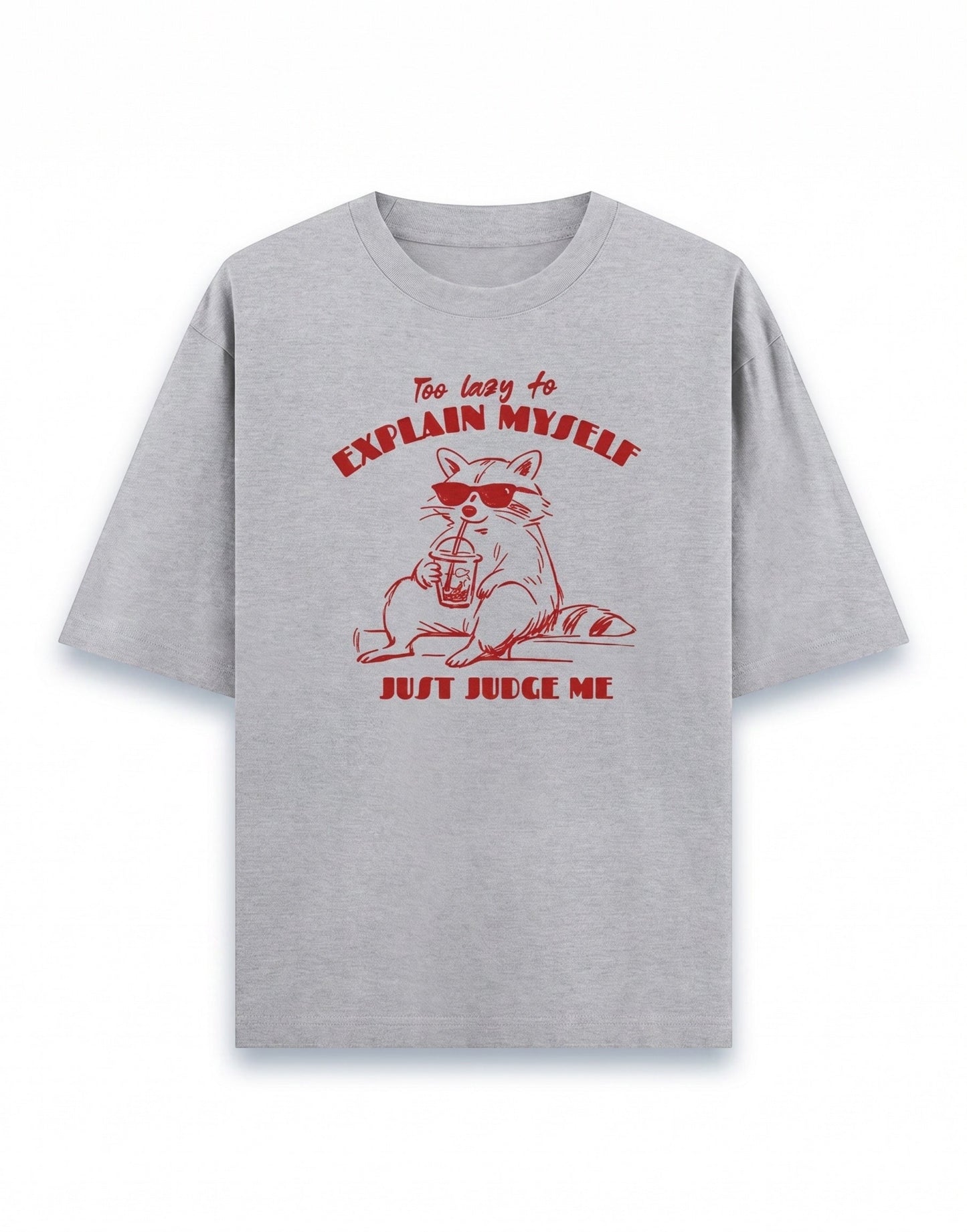Frolic Saga grey 100% cotton oversized t-shirt with a red graphic of a raccoon wearing sunglasses and holding a drink, text reads "Too lazy to explain myself, JUST JUDGE ME."