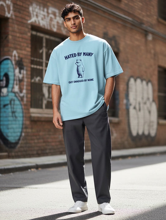 Frolic Saga light blue oversized t-shirt with vintage bear graphic and text "Hated By Many, Out Swagged By None".