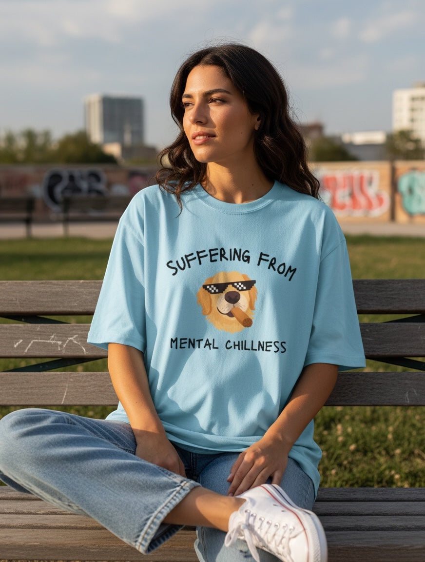 Frolic Saga light blue oversized t-shirt with a graphic of a Golden Retriever wearing pixelated sunglasses and smoking a cigar, with the text "Suffering From Mental Chillness".