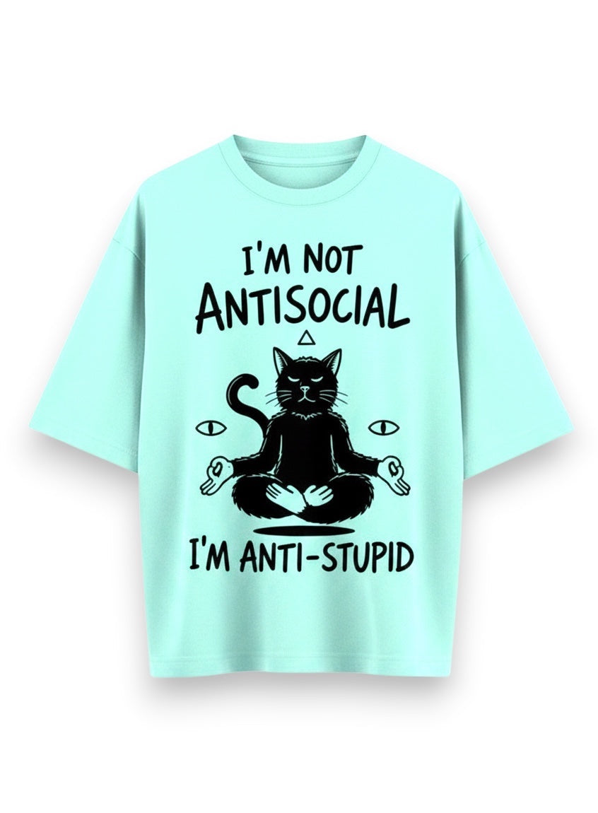 Frolic Saga unisex oversized t-shirt in mint green, 100% cotton, featuring a black graphic of a meditating cat with text "I'M NOT ANTISOCIAL I'M ANTI-STUPID".