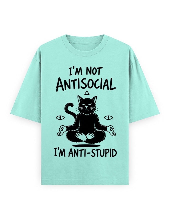 Frolic Saga unisex oversized t-shirt in mint green, 100% cotton, featuring a black graphic of a meditating cat with text "I'M NOT ANTISOCIAL I'M ANTI-STUPID".