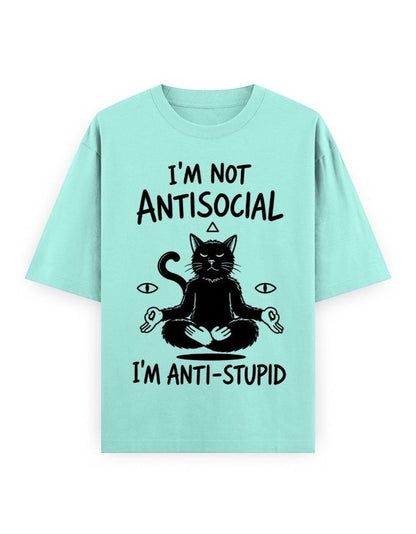 Frolic Saga unisex oversized t-shirt in mint green, 100% cotton, featuring a black graphic of a meditating cat with text "I'M NOT ANTISOCIAL I'M ANTI-STUPID".