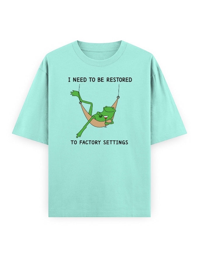 Frolic Saga unisex oversized t-shirt in mint green, 100% cotton, featuring a graphic of a frog in a hammock with text.
