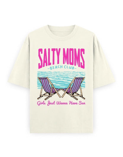Frolic Saga cream oversized 100% cotton tee with retro "Salty Moms Beach Club" graphic and "Girls Just Wanna Have Sun" slogan.