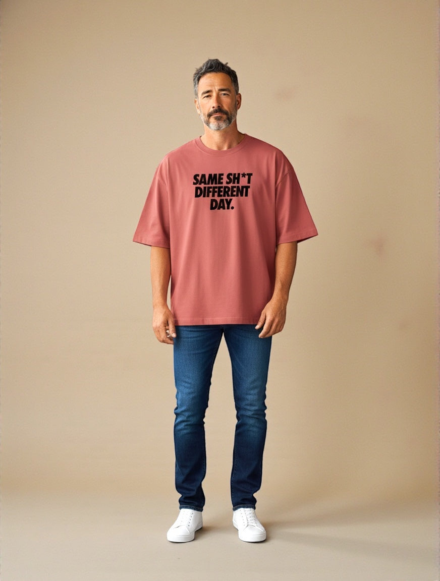 Frolic Saga Unisex oversized classic t-shirt in coral pink 100% cotton with graphic text 'SAME SH*T DIFFERENT DAY.'