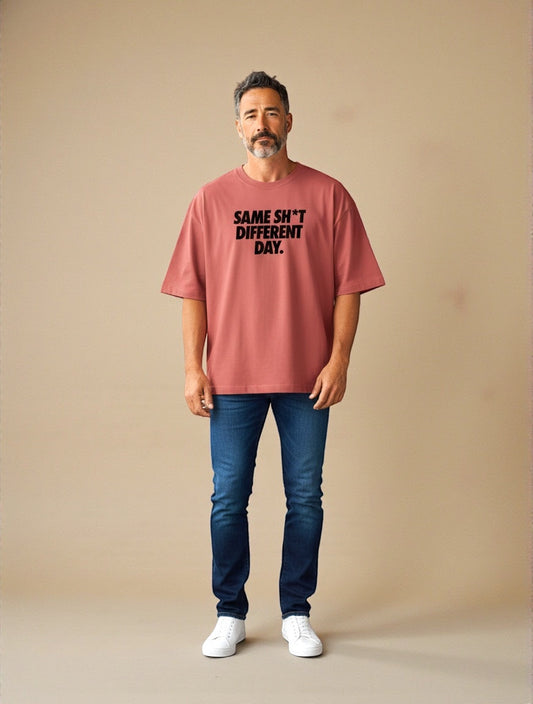Frolic Saga Unisex oversized classic t-shirt in coral pink 100% cotton with graphic text 'SAME SH*T DIFFERENT DAY.'