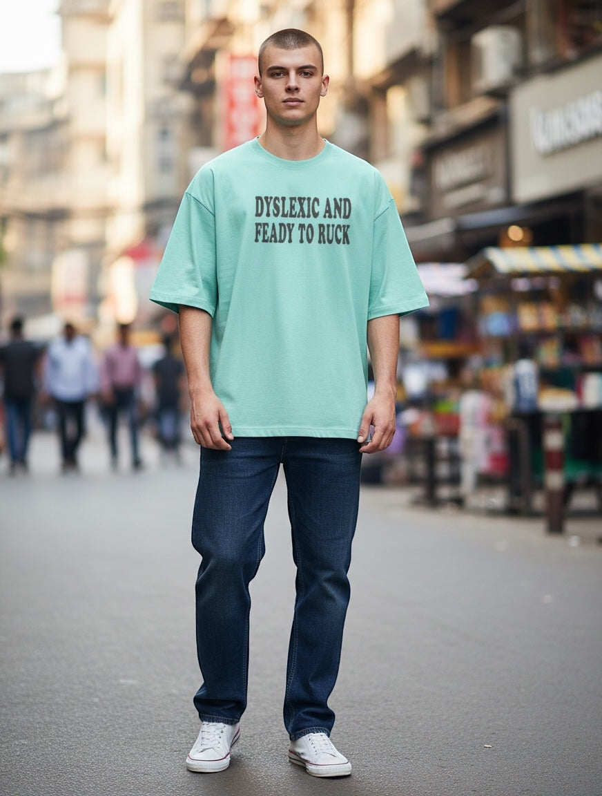 Frolic Saga unisex oversized mint green 100% cotton t-shirt with black text graphic on chest.