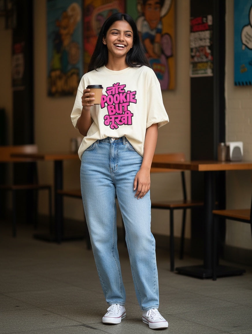 Frolic Saga cream 100% cotton oversized t-shirt with pink Hindi text graphic and dropped sleeves.