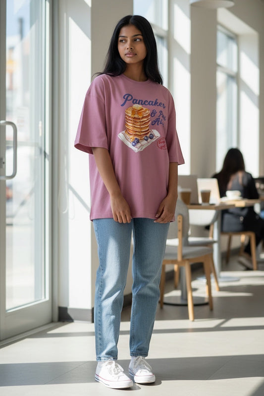 Frolic Saga oversized dusty rose French terry tee with "Pancake & Panic Attack" graphic print. 100% cotton.